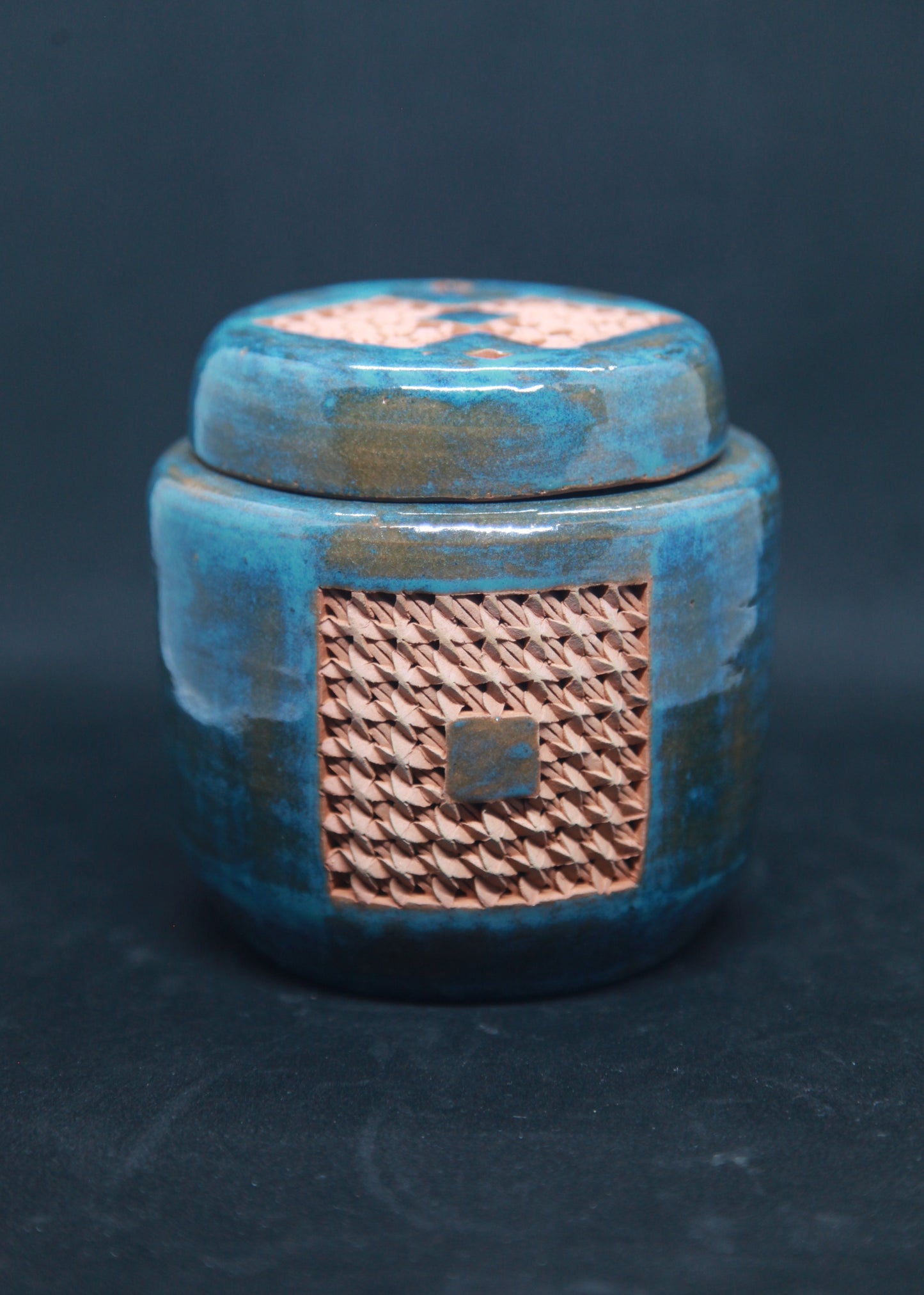 Turquoise blue tea box on red clay - braiding pattern