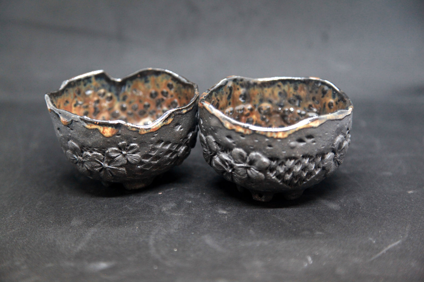 Amber cups on black clay - flower patterns