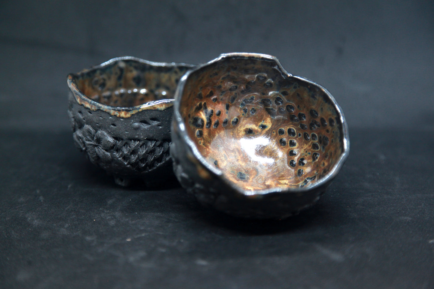 Amber cups on black clay - flower patterns