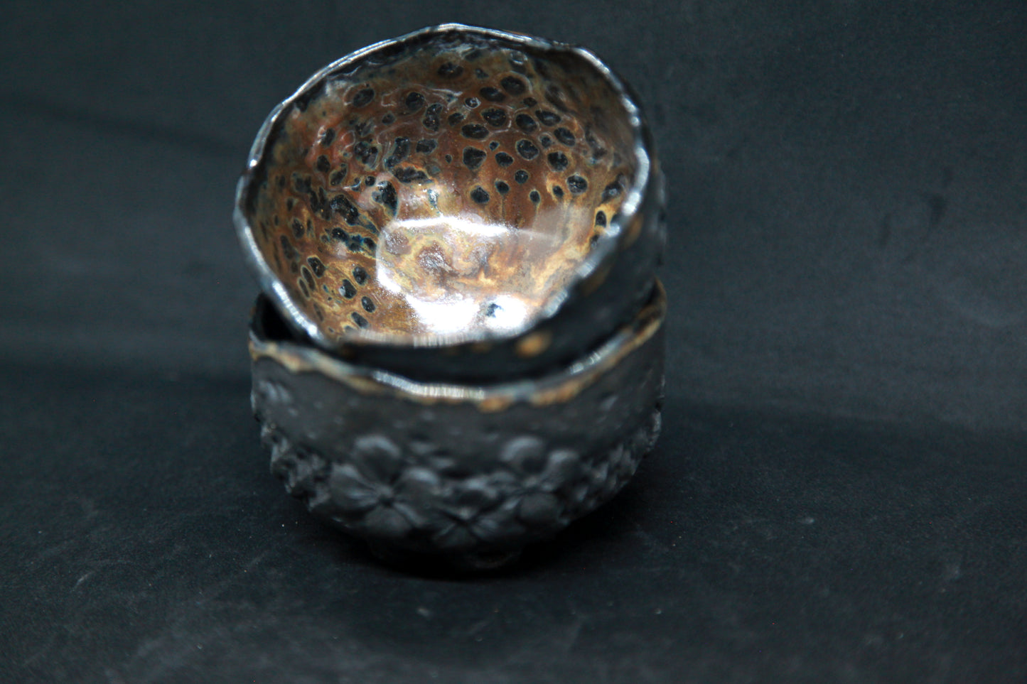 Amber cups on black clay - flower patterns