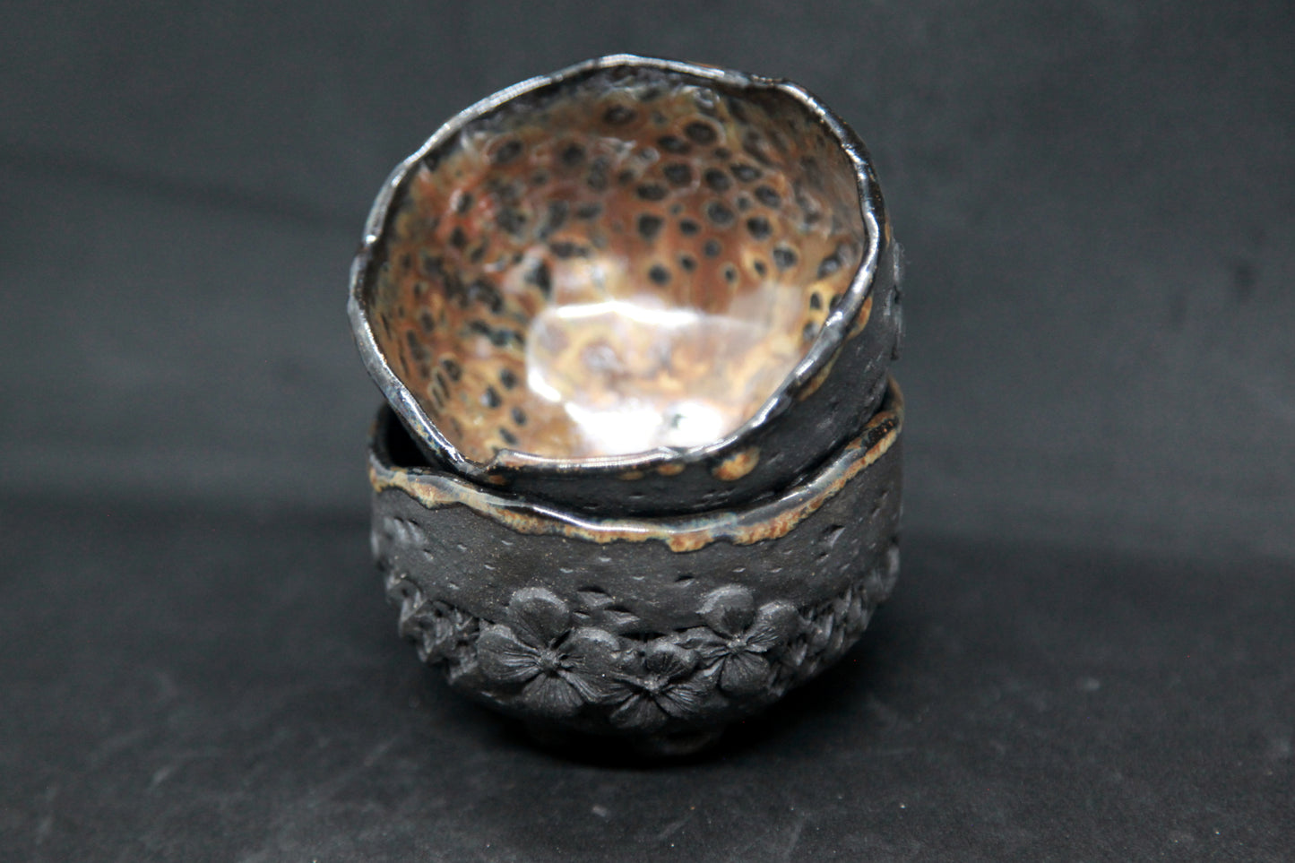 Amber cups on black clay - flower patterns